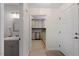 Hallway leads to a remodeled kitchen and bathroom with neutral paint and flooring and new stainless appliances at 205 Clancy Cir, Cary, NC 27511