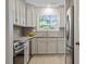 Kitchen with stainless steel appliances, gray cabinets and light-colored countertops at 205 Clancy Cir, Cary, NC 27511