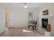 Bright living room with light-colored hardwood floors, white trim, a fireplace, and a ceiling fan at 205 Clancy Cir, Cary, NC 27511