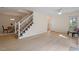 Open-concept living room with staircase and hardwood floors at 205 Clancy Cir, Cary, NC 27511