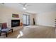 Bright living room featuring a fireplace, hardwood floors, and glass patio doors at 205 Clancy Cir, Cary, NC 27511