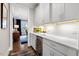 Stylish butler's pantry with white cabinets, beverage cooler, and bright lighting at 2104 Vandiver Way, Apex, NC 27523