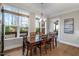 Dining room with a wooden table, large windows, and natural light at 2104 Vandiver Way, Apex, NC 27523