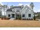 Beautiful two-story home featuring a manicured lawn and a classic painted brick exterior at 2104 Vandiver Way, Apex, NC 27523