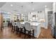 Bright kitchen with center island, pendant lighting, and white cabinets at 2104 Vandiver Way, Apex, NC 27523