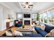 Spacious living room with modern fireplace, coffered ceiling, and ample natural light at 2104 Vandiver Way, Apex, NC 27523