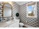 Elegant powder room with stylish wallpaper, vanity, and natural light at 2104 Vandiver Way, Apex, NC 27523