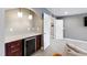 Stylish bar area features granite countertops, cabinetry, beverage cooler, and pendant lighting at 222 Friesan Way, Rolesville, NC 27571