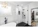 Spa-like bathroom features a glass shower, black hardware and fixtures, and hexagon tile floors at 222 Friesan Way, Rolesville, NC 27571