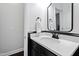 Modern bathroom with white countertop, black fixtures, and a framed mirror at 222 Friesan Way, Rolesville, NC 27571