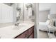Bathroom vanity with a marble countertop, dark wood cabinets, and chrome fixtures at 222 Friesan Way, Rolesville, NC 27571