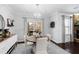 Cozy breakfast nook with sliding doors, round table and stylish chandelier lighting at 222 Friesan Way, Rolesville, NC 27571