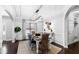 Dining room with modern light fixture, decorative wall art and seating for six at 222 Friesan Way, Rolesville, NC 27571