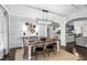 Dining room with modern light fixture, decorative wall art and seating for six at 222 Friesan Way, Rolesville, NC 27571