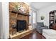 Close-up of a stone fireplace with decorative mantel, clock, and hearth at 222 Friesan Way, Rolesville, NC 27571