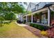 Inviting front porch featuring stone accents, comfortable seating, and manicured landscaping at 222 Friesan Way, Rolesville, NC 27571
