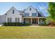 Charming two-story home with inviting front porch and beautifully landscaped front yard at 222 Friesan Way, Rolesville, NC 27571
