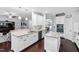 Bright open concept kitchen with white cabinets, granite countertops and a central island at 222 Friesan Way, Rolesville, NC 27571