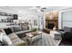 Open concept living room featuring a stone fireplace, ceiling fan and comfortable seating at 222 Friesan Way, Rolesville, NC 27571