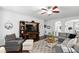 Bright living room with hardwood floors, gray sofa and a decorative stone fireplace at 222 Friesan Way, Rolesville, NC 27571