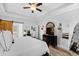 Relaxing main bedroom features tray ceiling, wood floors, and a barn door to the bathroom at 222 Friesan Way, Rolesville, NC 27571