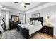 Cozy main bedroom features tray ceiling, neutral decor, and large windows for natural light at 222 Friesan Way, Rolesville, NC 27571