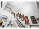Elegant staircase with Gathering portraits and wooden banister, leading to the upper level at 222 Friesan Way, Rolesville, NC 27571