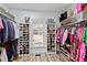 Well-organized walk-in closet featuring shelving, hanging racks, and natural light from the window at 222 Friesan Way, Rolesville, NC 27571