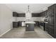 Modern kitchen with dark cabinets, an island, and stainless steel appliances at 248 Dutches Ln, Henderson, NC 27537