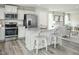 Modern kitchen featuring stainless steel appliances, a center island with seating, and ample natural light at 26 Artesa Ct, Fuquay Varina, NC 27526