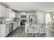 Stylish kitchen features white cabinets, stainless steel appliances, and a convenient center island with bar stool seating at 26 Artesa Ct, Fuquay Varina, NC 27526