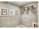 Functional laundry room with laundry-themed wall art, shelving, and neutral-toned walls at 26 Artesa Ct, Fuquay Varina, NC 27526