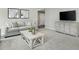 Comfortable living room features neutral tones, plush carpeting, stylish furnishings, and a modern entertainment center at 26 Artesa Ct, Fuquay Varina, NC 27526