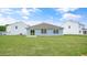 View of the backyard featuring a light blue home with a sliding glass door at 267 Palm Dr, Sanford, NC 27332