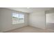 Bright bedroom features a large window letting in natural light and neutral carpet at 267 Palm Dr, Sanford, NC 27332