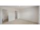 Spacious bedroom has neutral carpeting, and doorways to a closet and bathroom at 267 Palm Dr, Sanford, NC 27332