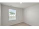 Minimalist bedroom with plush carpet, bright window and outlets visible on neutral walls at 267 Palm Dr, Sanford, NC 27332