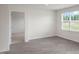 Bedroom with neutral carpet, a window, and a view to an adjacent room at 267 Palm Dr, Sanford, NC 27332