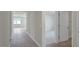 Open hallway with wood flooring leading to bedrooms with neutral carpet and ample natural light at 267 Palm Dr, Sanford, NC 27332