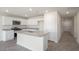 Modern kitchen with white cabinets, granite countertops, stainless steel appliances, and wood-look flooring at 267 Palm Dr, Sanford, NC 27332