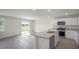 Bright kitchen features stainless appliances, granite countertops, and a view to the backyard at 267 Palm Dr, Sanford, NC 27332