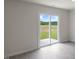 Living room with vinyl flooring and a backyard view at 267 Palm Dr, Sanford, NC 27332