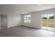 Bright living room with vinyl flooring, a window and a backyard view at 267 Palm Dr, Sanford, NC 27332