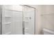 Shower with glass doors, multiple shelves, and chrome fixtures at 267 Palm Dr, Sanford, NC 27332