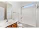 A bathroom featuring a shower-tub combo, a white vanity, and a sunny window at 3 Rencher Ct, Durham, NC 27703