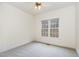 Bright bedroom featuring neutral carpeting, a ceiling fan and a large window at 3 Rencher Ct, Durham, NC 27703