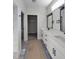 Bright bathroom featuring double vanity, black hardware, and recessed lighting at 307 7Th St, Butner, NC 27509