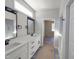 Bathroom featuring double sinks, black fixtures, and a walk-in tiled shower at 307 7Th St, Butner, NC 27509