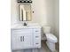 Bathroom vanity with white countertops, black fixtures, and a framed mirror above the sink at 307 7Th St, Butner, NC 27509
