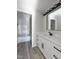 Bathroom featuring a white vanity with dark fixtures and a tiled shower at 307 7Th St, Butner, NC 27509